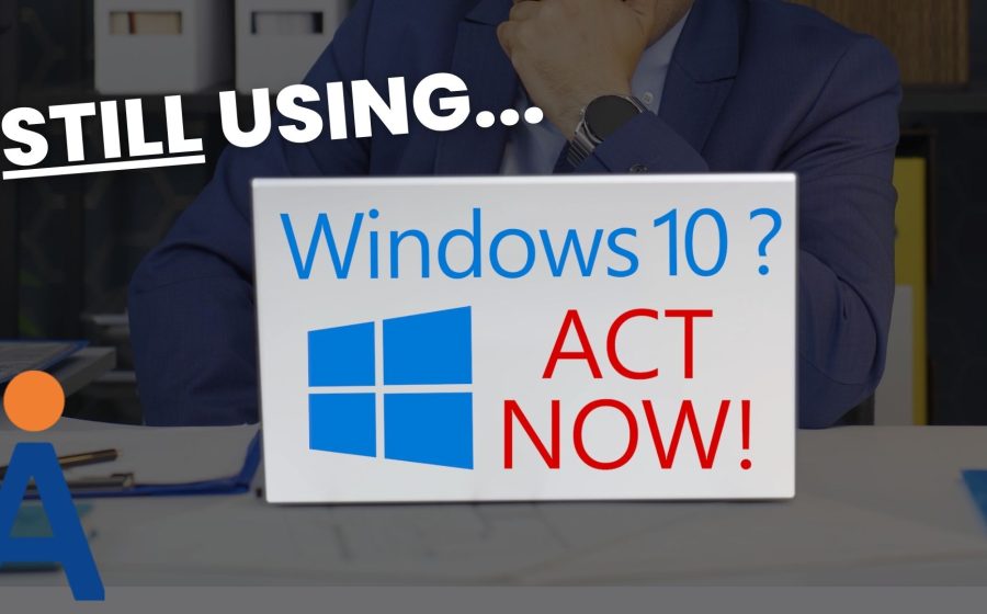 A person in a suit sits at a desk with a laptop. On the laptop screen, text reads “Windows 10? ACT NOW!” Above, bold text says “STILL USING...” The image urges action regarding Windows 10.